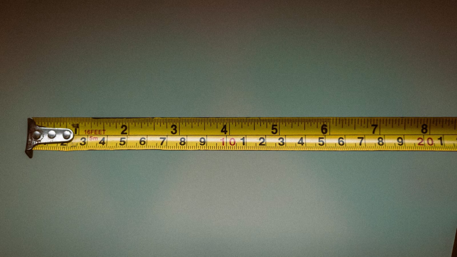 A tape measure pulled out to measure a room before buying a TV