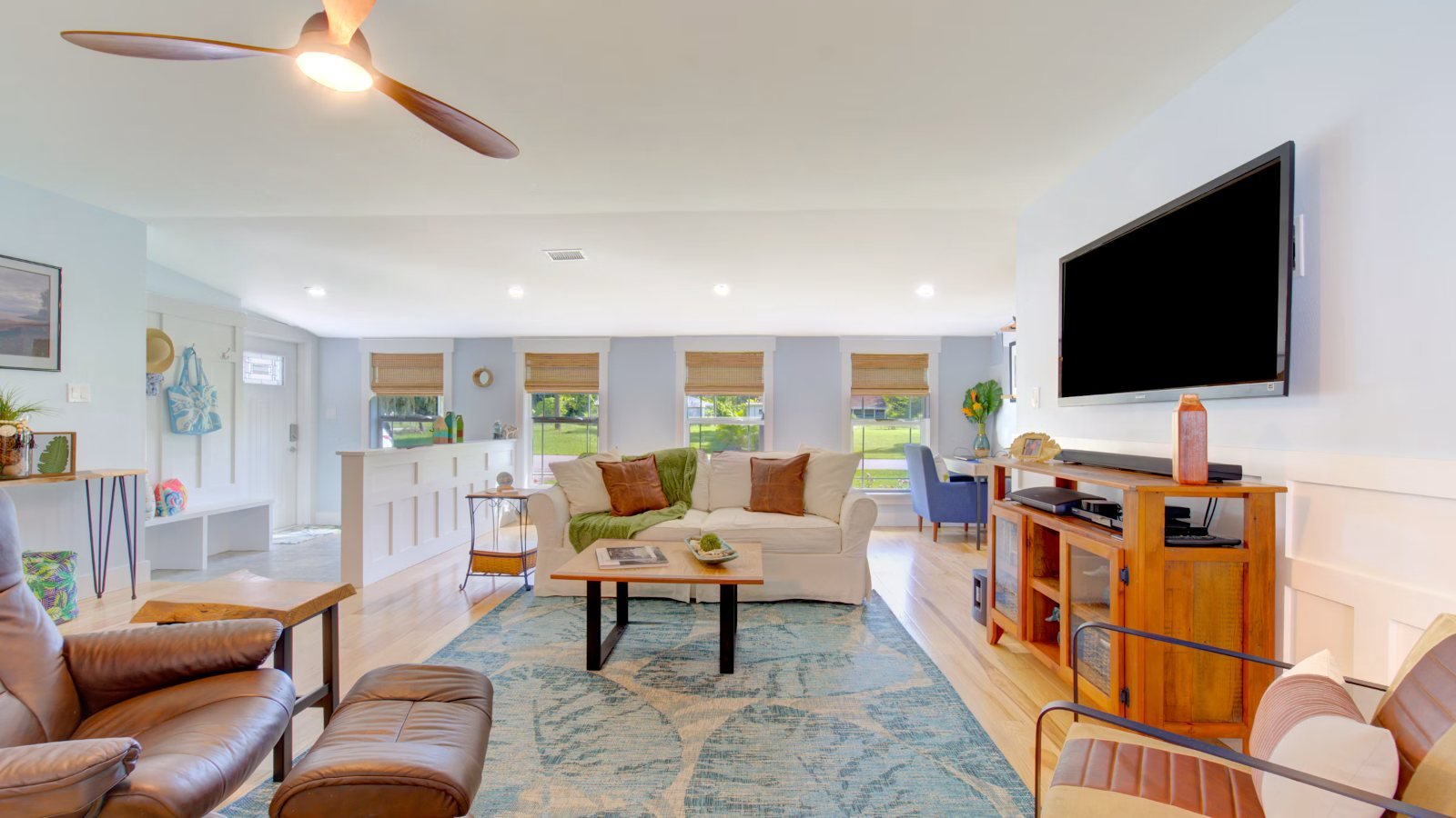 A large open-plan living room with a wall-mounted TV