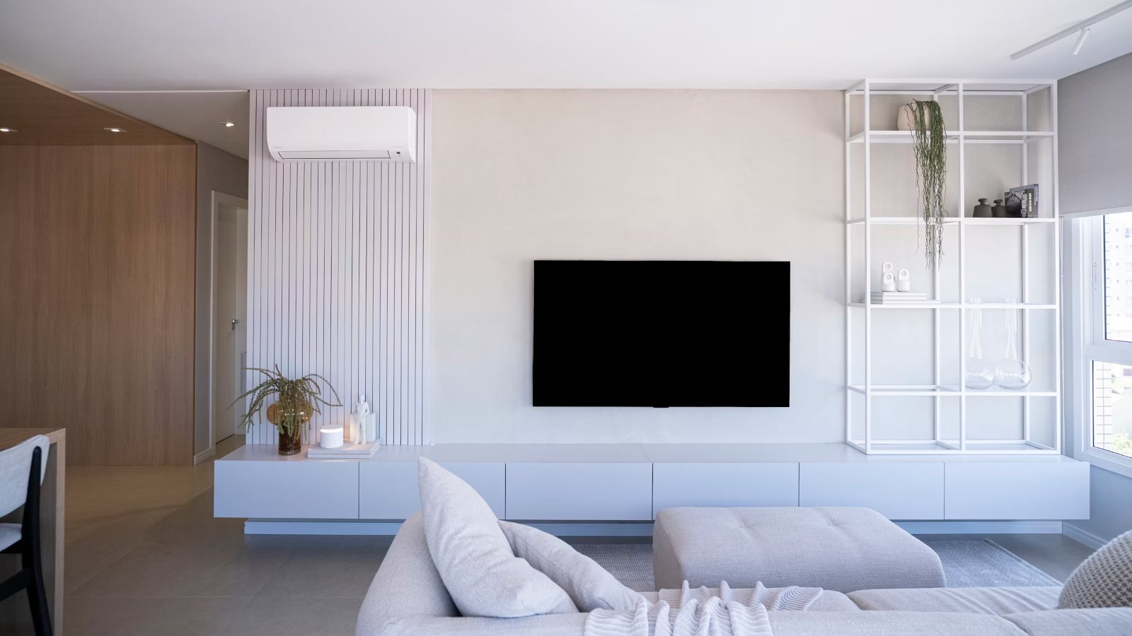 TV size for room planning: a sofa facing a wall-mounted TV in a living room